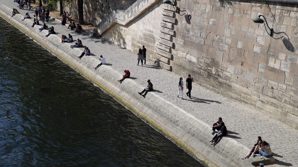 FILE: Parisians sit in the sun along Seine river banks in Paris, May 23, 2020