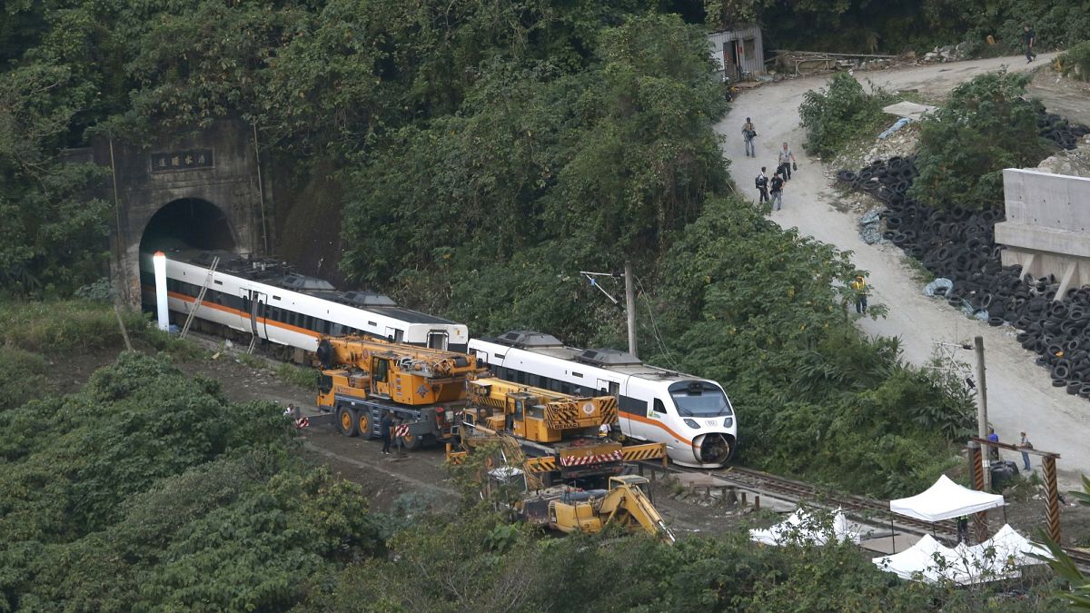 Rescue workers remove a part of the derailed train near Taroko Gorge in Hualien, Taiwan on Saturday, April 3, 2021.