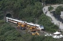 Rescue workers remove a part of the derailed train near Taroko Gorge in Hualien, Taiwan on Saturday, April 3, 2021.