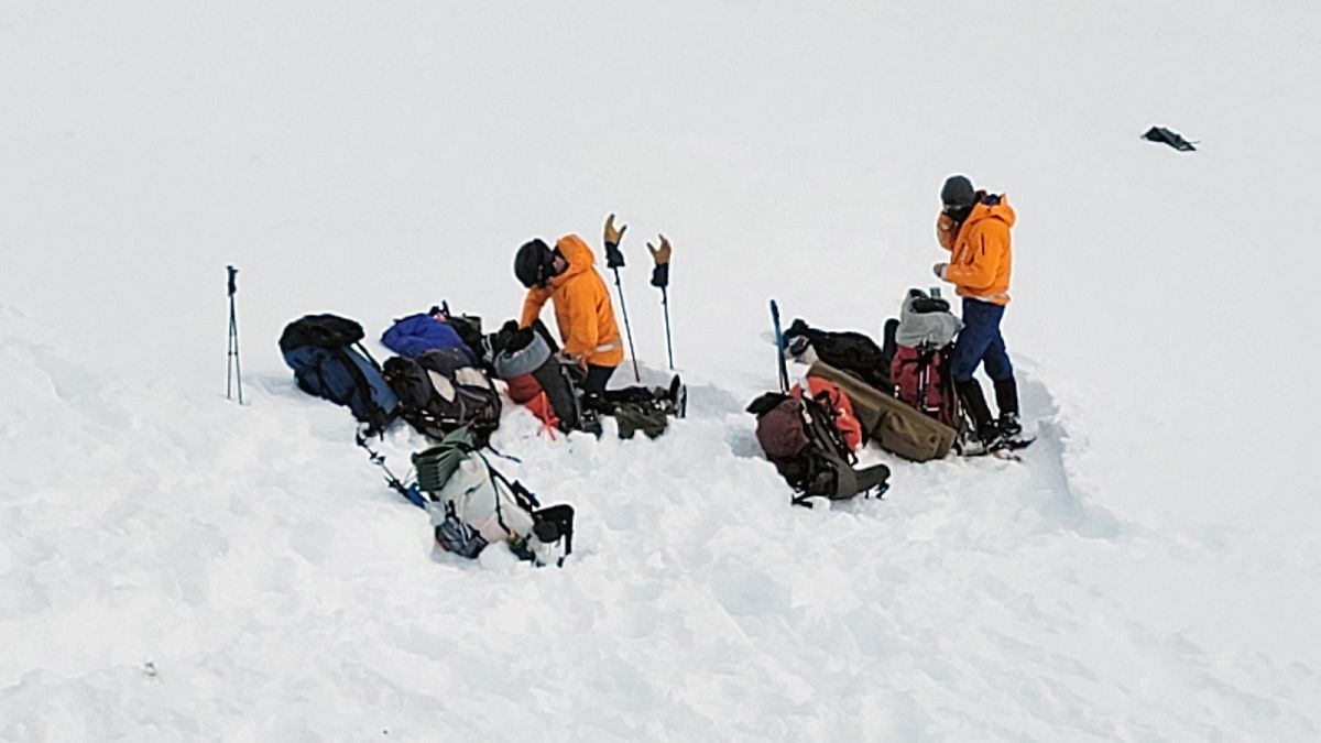 Volunteers work near the scene of a helicopter crash close to the Knik Glacier in Alaska on Sunday, March 28, 2021. 