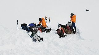 Volunteers work near the scene of a helicopter crash close to the Knik Glacier in Alaska on Sunday, March 28, 2021. 