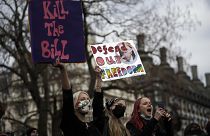 Demonstrators hold posters during a 'Kill the Bill' protest in London, Saturday, April 3, 2021.