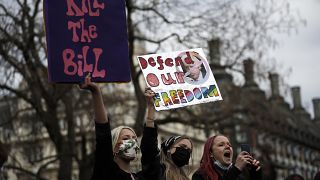 Demonstrators hold posters during a 'Kill the Bill' protest in London, Saturday, April 3, 2021.