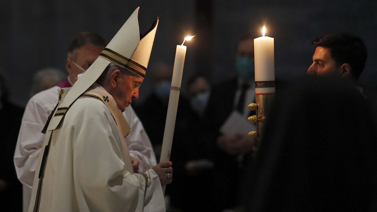 Pope Francis celebrates the Easter Vigil in a nearly empty St. Peter's Basilica as coronavirus pandemic restrictions stay in place for a second year running, at the Vatican.