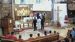 A police officer asks worshippers to leave a church in South London