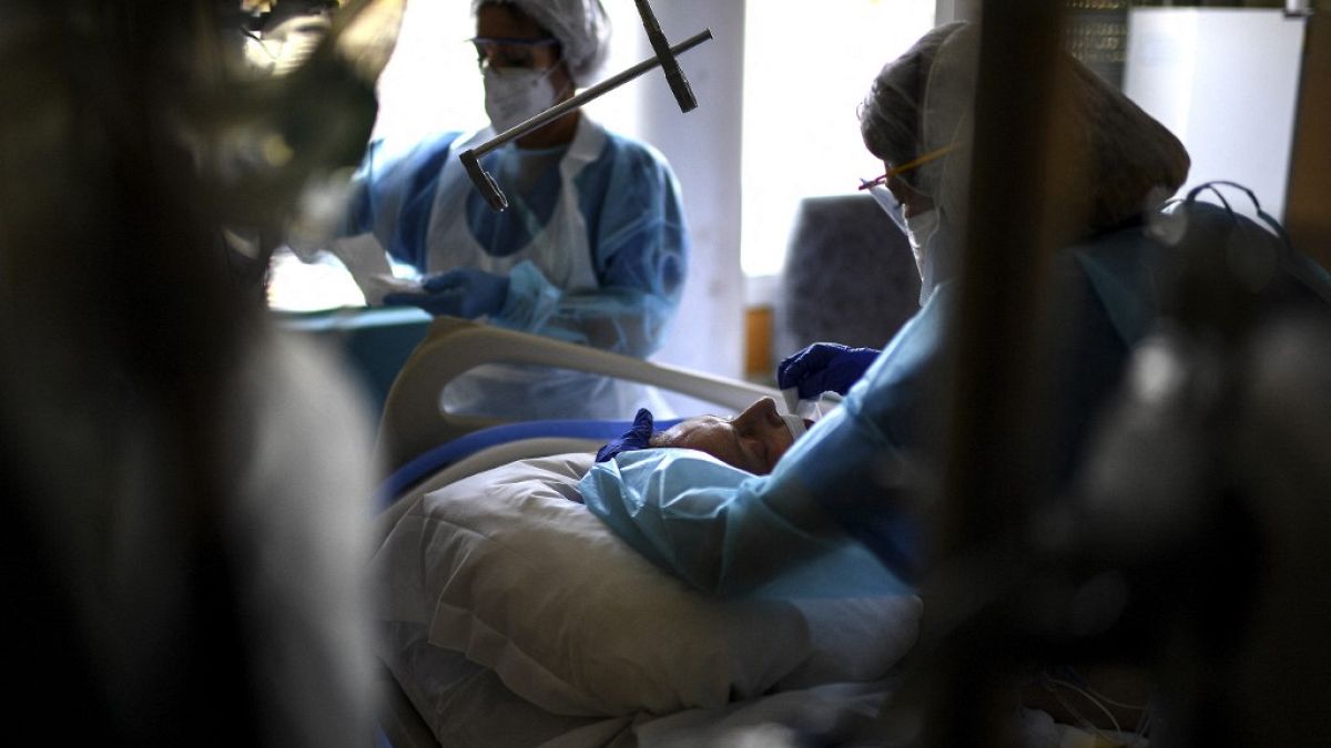 Nurses tend to a Covid-19 patient under respiratory assistance lying unconscious in the intensive care unit of the Hopital Prive hospital in Antony, France, April 2, 2021.