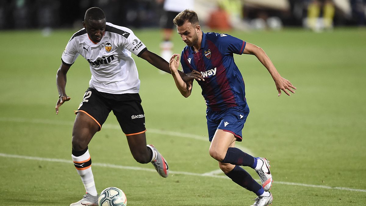 FILE PHOTO: Valencia's French defender Mouctar Diakhaby (L) vies with Levante's Spanish forward Borja Mayoral during A Spanish League football match, June 12, 2020.