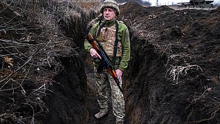 A Ukrainian serviceman, who asked to be identified only by his call sign, Kram, stands at his post in the town of Krasnohorlivka, eastern Ukraine, Friday, March 5