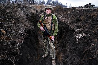 A Ukrainian serviceman, who asked to be identified only by his call sign, Kram, stands at his post in the town of Krasnohorlivka, eastern Ukraine, Friday, March 5
