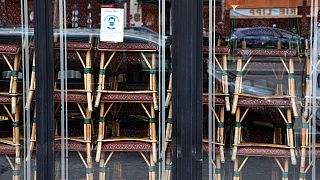 FILE: Chairs are stacked inside the famous Cafe de Flore closed along with all cafes and restaurants, Paris, France, March 15, 2021 