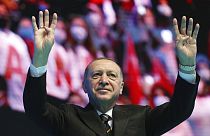 Erdogan waves to supporters during his ruling party's congress inside a packed sports hall in Ankara, Turkey, Wednesday, March 24, 2021.