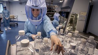 A laboratory worker simulates the workflow in a cleanroom of the BioNTech vaccine production in Marburg, Germany, during a media day on Saturday, March 27, 2021.