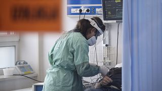 A medical worker attends to a patient suffering from COVID-19 in the emergency ward at the hospital in Bochnia.