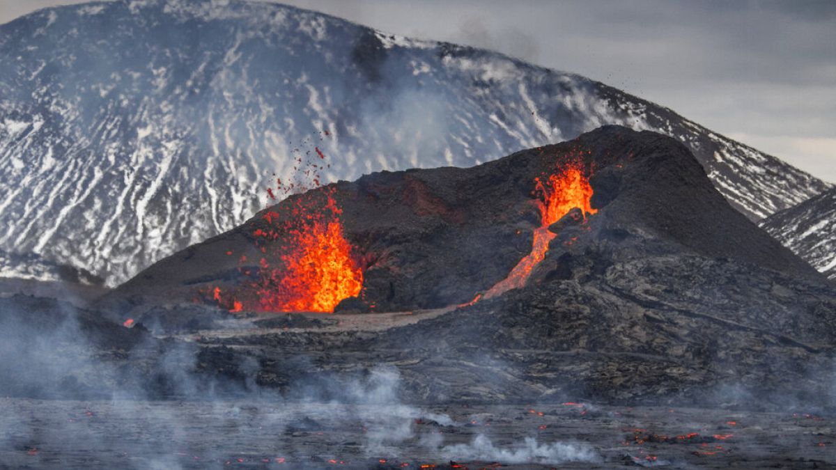 Steam and lava spurt from a new fissure on a volcano on the Reykjanes Peninsula in southwestern Iceland, Monday, April 5, 2021.