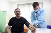 Serbian President Aleksandar Vucic, left, has his blood pressure taken before receiving a shot of the Chinese Sinopharm vaccine in the village of Rudna Glava, Serbia.