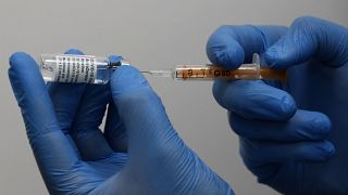FILE: A doctor prepares the AstraZeneca vaccine at a Pharmacy in Edgeware, London, Tuesday, March 16, 2021. 