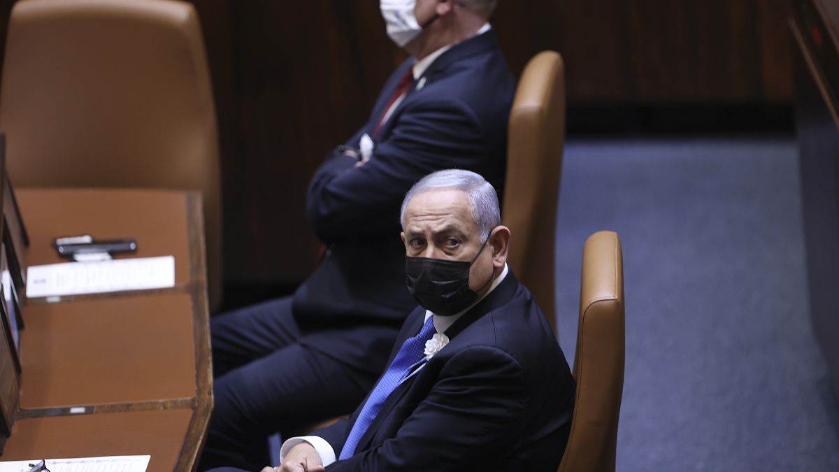 Israeli Prime Minister Benjamin Netanyahu, front, attends the swearing-in ceremony for Israel's 24th government at the Knesset in Jerusalem, Tuesday, April 6, 2021. 