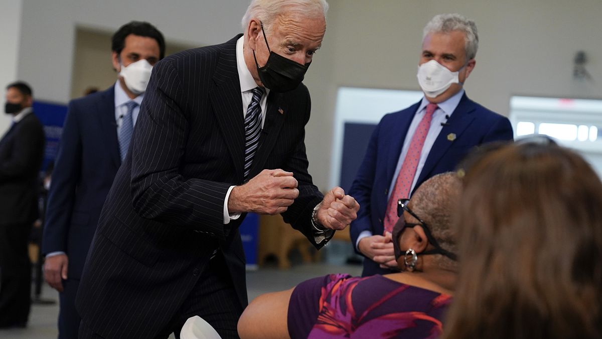 President Joe Biden talks to a person receiving a COVID-19 vaccination shot as he visits a vaccination site at Virginia Theological Seminary, Tuesday, April 6, 2021.