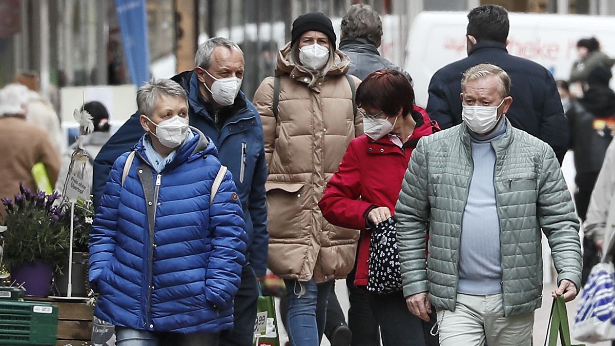 People wear face masks at a shopping street in Gelsenkirchen, Germany, Tuesday, April 6, 2021.