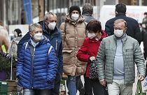 People wear face masks at a shopping street in Gelsenkirchen, Germany, Tuesday, April 6, 2021.