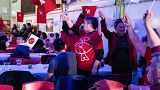 Members of the IA (Inuit Ataqatigiit) party celebrate following Tuesday's exit poll results in Nuuk.