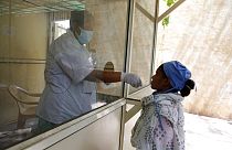 A health worker takes a swab sample to test for COVID-19 outside shopping mall in Ahmedabad, India, Saturday, April 3, 2021.