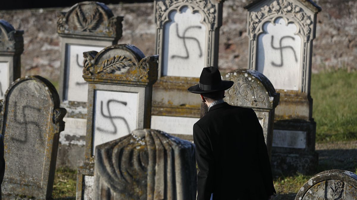 In this Dec. 4, 2019 file photo, Strasbourg chief Rabbi Harold Abraham Weill looks at vandalized tombs in the Jewish cemetery of Westhoffen, west of the city of Strasbourg.