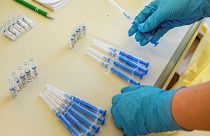 A health worker readies vials of Russia's Sputnik V vaccine