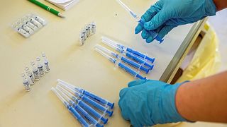 A health worker readies vials of Russia's Sputnik V vaccine