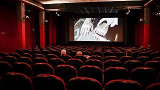 People sit in a cinema in Milan, Italy, Monday, June 15, 2020