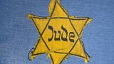 In this Wednesday, Jan. 22, 2014 file photo, the Yellow Star badge of Heinz-Joachim Aris (Dresden 1941) reading 'Jew' is displayed at the Military History Museum in Dresden.