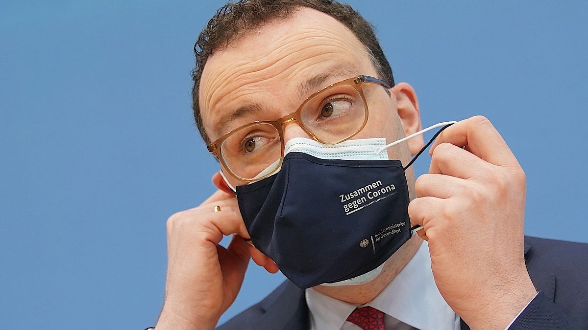 Jens Spahn, Federal Minister of Health, takes off his mouth-nose protection at the Federal Press Conference in Berlin, Germany, Thursday, April 1, 2021.
