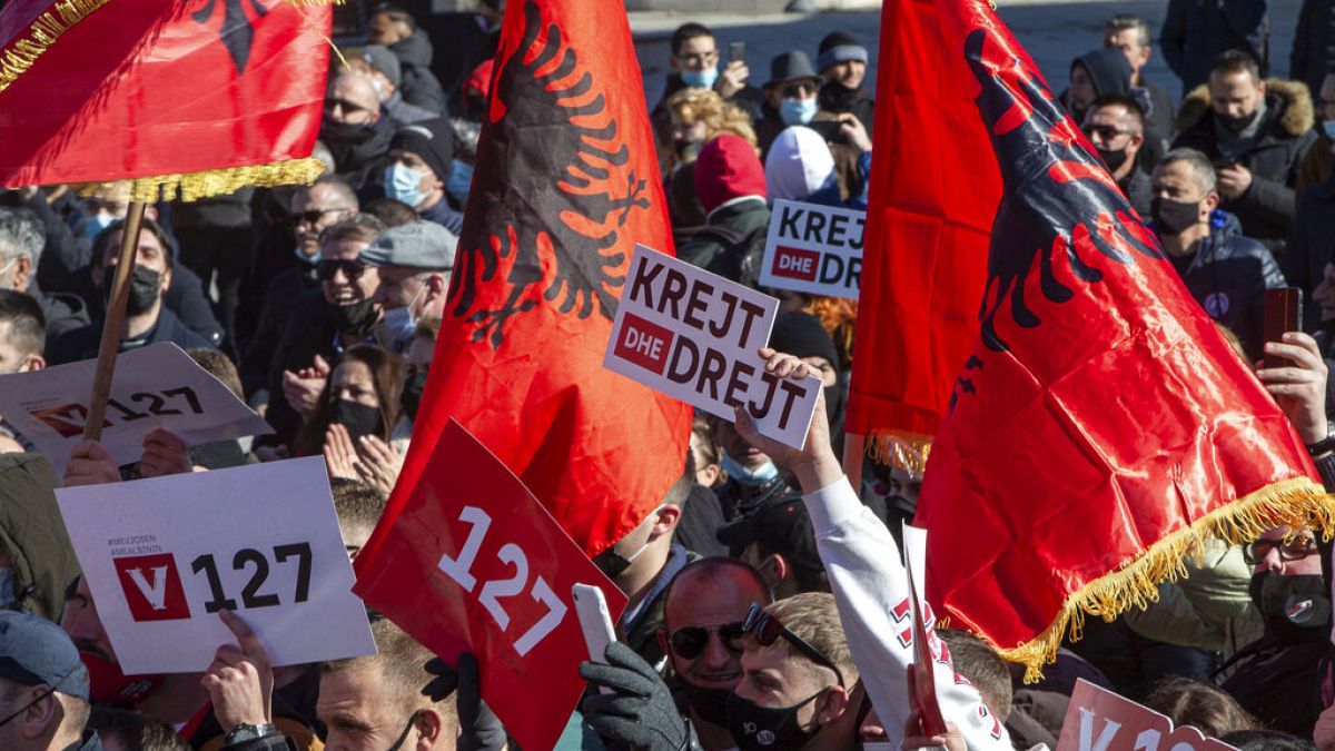 Supporter of VETEVENDOSJE (Self-Determination) political party holds a slogan reading in Albanian " All and Straight" during the closing electoral rally in capital Pristina.
