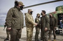 Ukrainian President Volodymyr Zelenskiy shakes hands a soldier as he visits the war-hit Donetsk region, eastern Ukraine, Thursday, April 8, 2021.