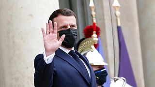 French President Emmanuel Macron gestures toward journalists prior to welcome Israeli President Reuven Rivlin, at the Elysee Palace, in Paris, Thursday, March 18, 2021.