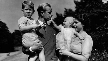 In this August 1951 photo, Princess Elizabeth stands with her husband Prince Philip, the Duke of Edinburgh, and their children Prince Charles and Princess Anne