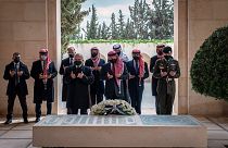 Jordan’s King Abdullah II, center, Prince Hamzah bin Al Hussein, second left, and others visit the tomb of the late King Hussein, in Amman Jordan. April 11, 2021.