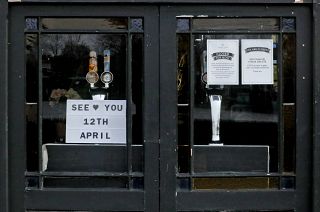The window of The Rutland Arms pub shows their opening date in Hammersmith, London, Wednesday, April 7, 2021.