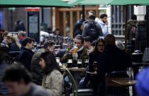 Customers are served at outdoor tables in London's Soho on Monday