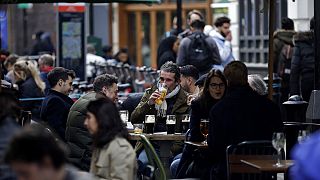 Customers are served at outdoor tables in London's Soho on Monday