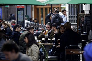 Customers are served at outdoor tables in London's Soho on Monday