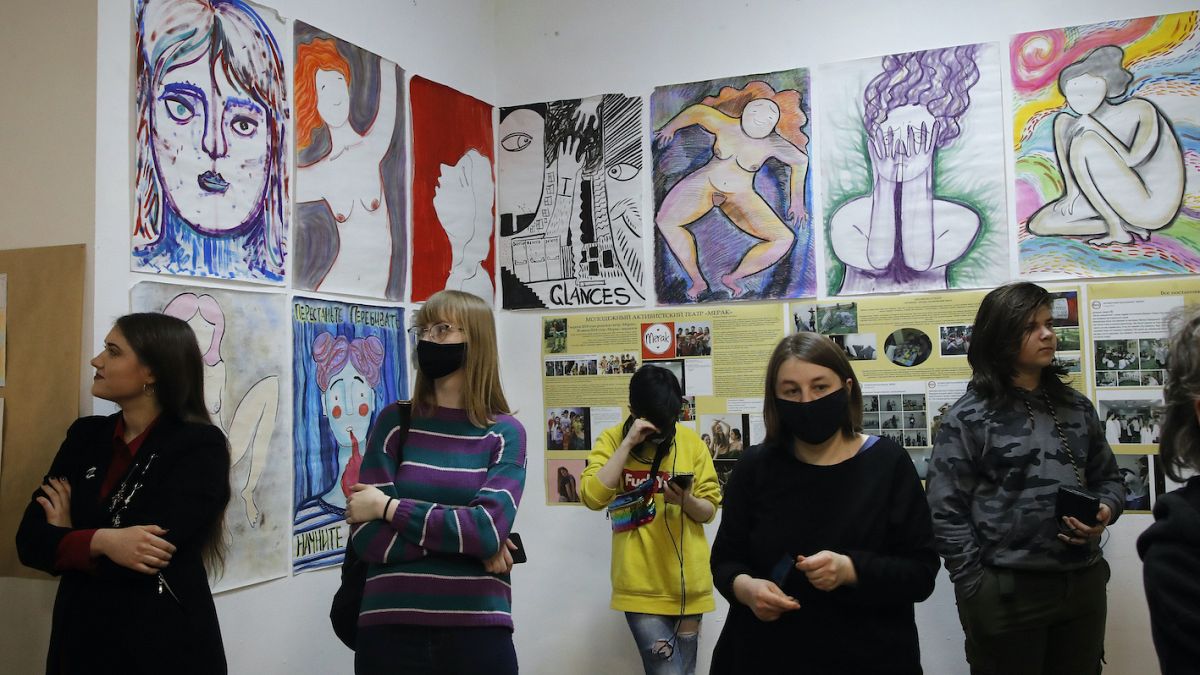 Visitors look at the exhibition of Yulia Tsvetkova's paintings in St. Petersburg, Russia, Saturday, April 10, 2021. 