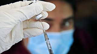 A nurse prepares a dose of the Pfizer-BioNTech vaccine against the COVID-19 for a health worker