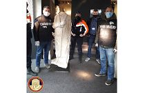 Italian antiquities police the Carabinieri Art Squad with the recovered statue in Brussels