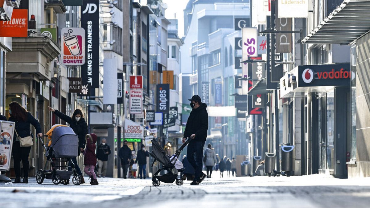 FILE: people walk on the main shopping street in Cologne Germany - Dec. 16, 2020.