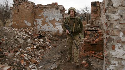A Ukrainian serviceman patrols near the frontline in the fight against Russian-backed separatists near the small city of Marinka, Donetsk region