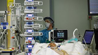 A medical staff member tends to a patient in the COVID-19 intensive care unit at the Pope John XXIII hospital, in Bergamo, Italy, Thursday, March 18, 2021.