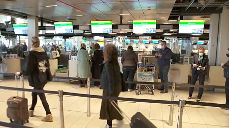 The tourists check in for their flight to Rhodes, Greece at Amsterdam's Schipol Airport on Monday