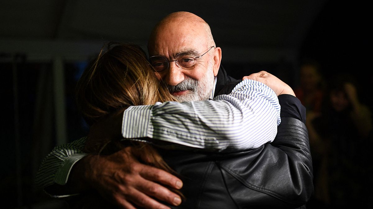 Turkish journalist and writer Ahmet Altan (C) hugs his friends and relatives after being realised briefly on November 4, 2019