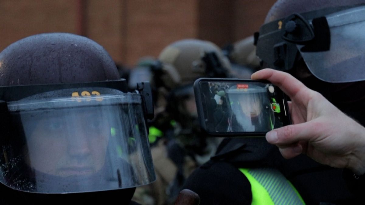 Protestor films state patrol personnel’s faces up close with cell phone